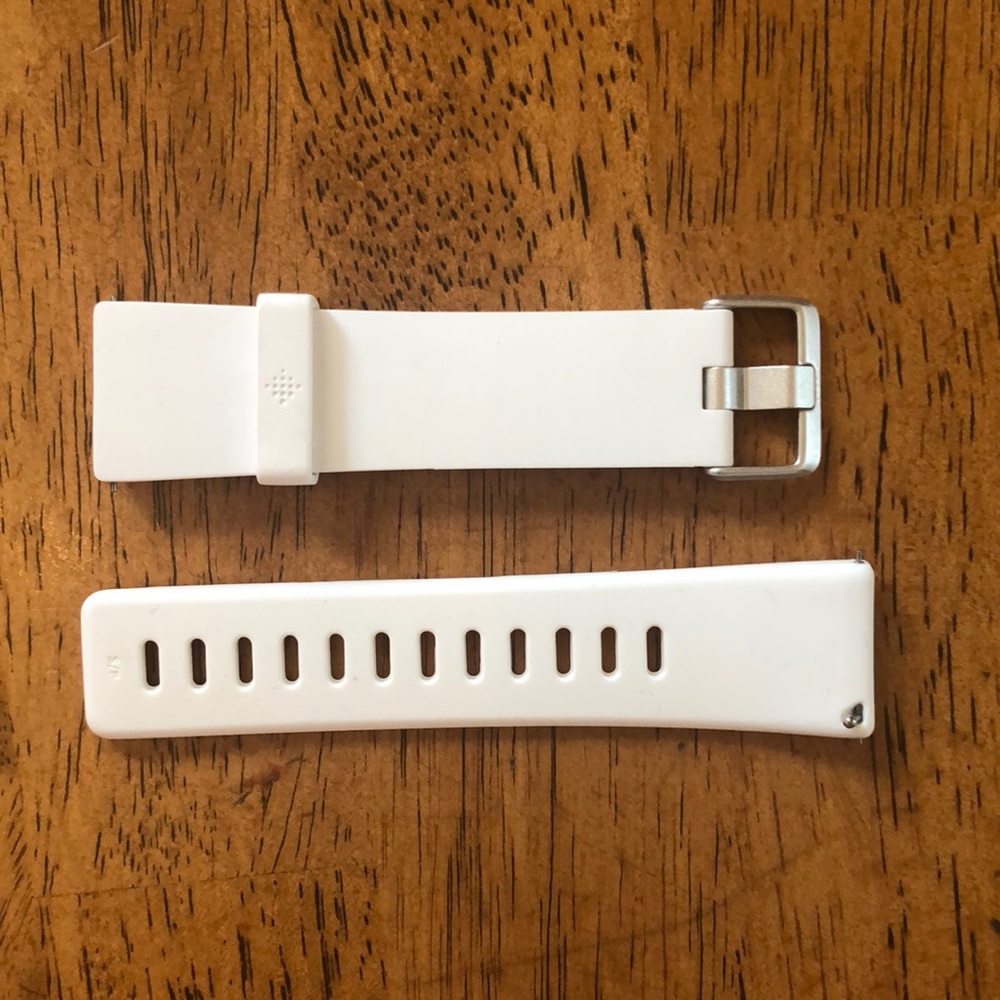 White Fitbit Versa watch strap.